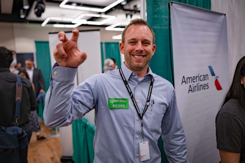 A photo of a UNT alumni who returned to campus to participate in a career fair representing american airlines.