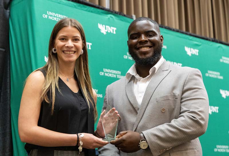 A photo from the student employee appreciation lunch showing a student employee receiving an award.
